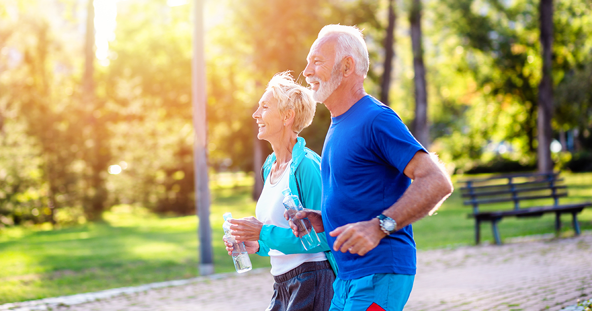 Active older couple enjoying exercise outdoors, reflecting healthy aging and long-term wellness